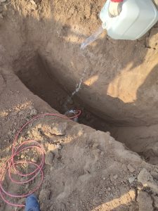 آب‌دهی چاه آند فداشونده منیزیم با آب برای کاهش مقاومت الکتریکی خاک و برقراری اتصال پایدار آند با زمین، پیش از خاک‌ریزی نهایی در پروژه حفاظت کاتدیک خط لوله